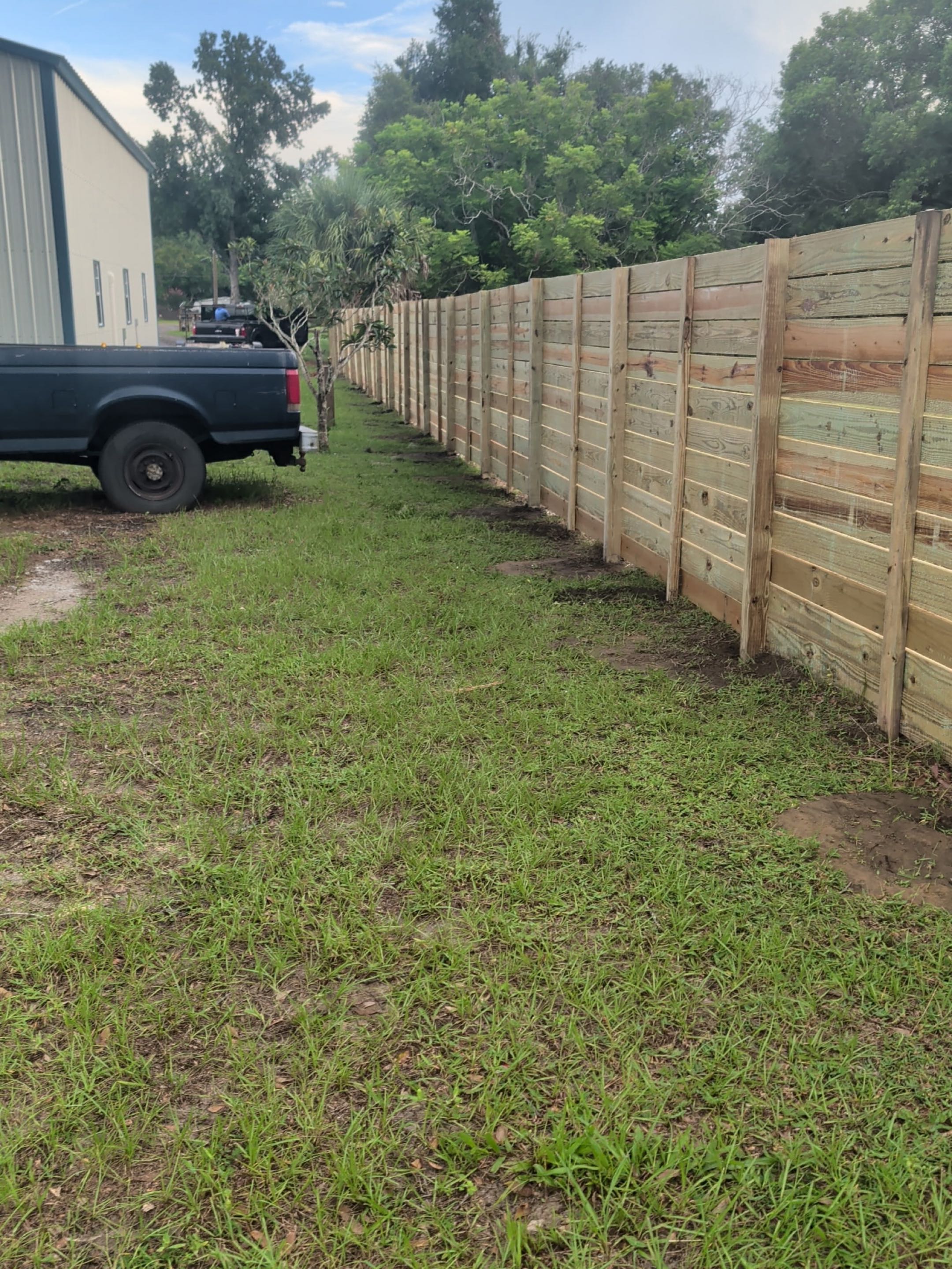 Odessa, FL - Our team meticulously crafted a stunning privacy fence, transforming the outdoor space into a secure and elegant sanctuary. We began by carefully measuring the area to ensure precise dimensions. Each section of the fence was constructed using high-quality materials, chosen for their durability and aesthetic appeal. The posts were anchored firmly into the ground, providing a solid foundation. We then installed the panels, ensuring they were level and securely fastened. Attention to detail was paramount, with each joint and connection meticulously finished to maintain a seamless look. The final result is a fence that not only offers privacy but also enhances the beauty of the property, creating a perfect blend of functionality and style.