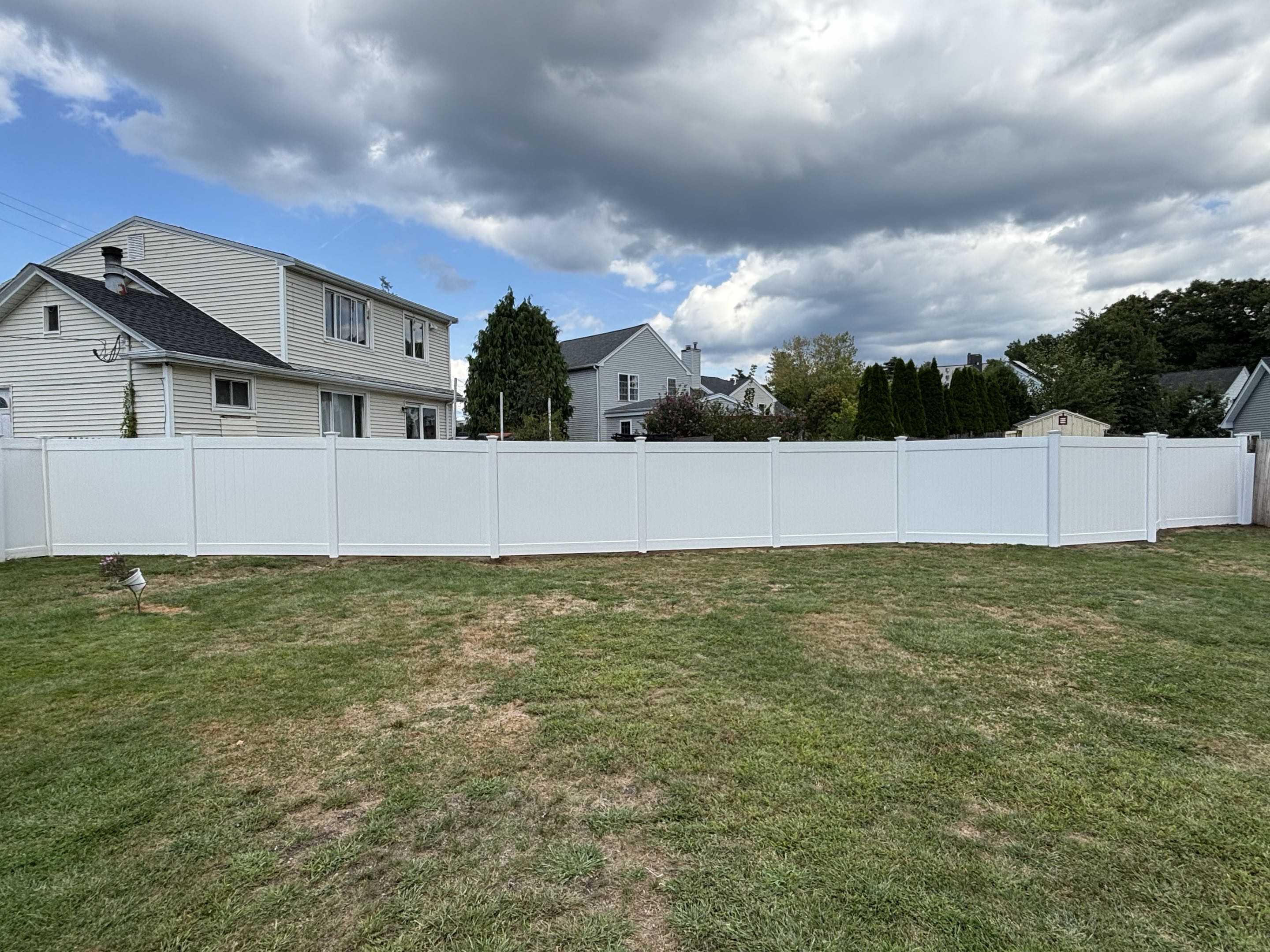 Framingham, MA - 6 foot vinyl privacy fence in Framingham. We had to get a little creative to work around a very large boulder. 