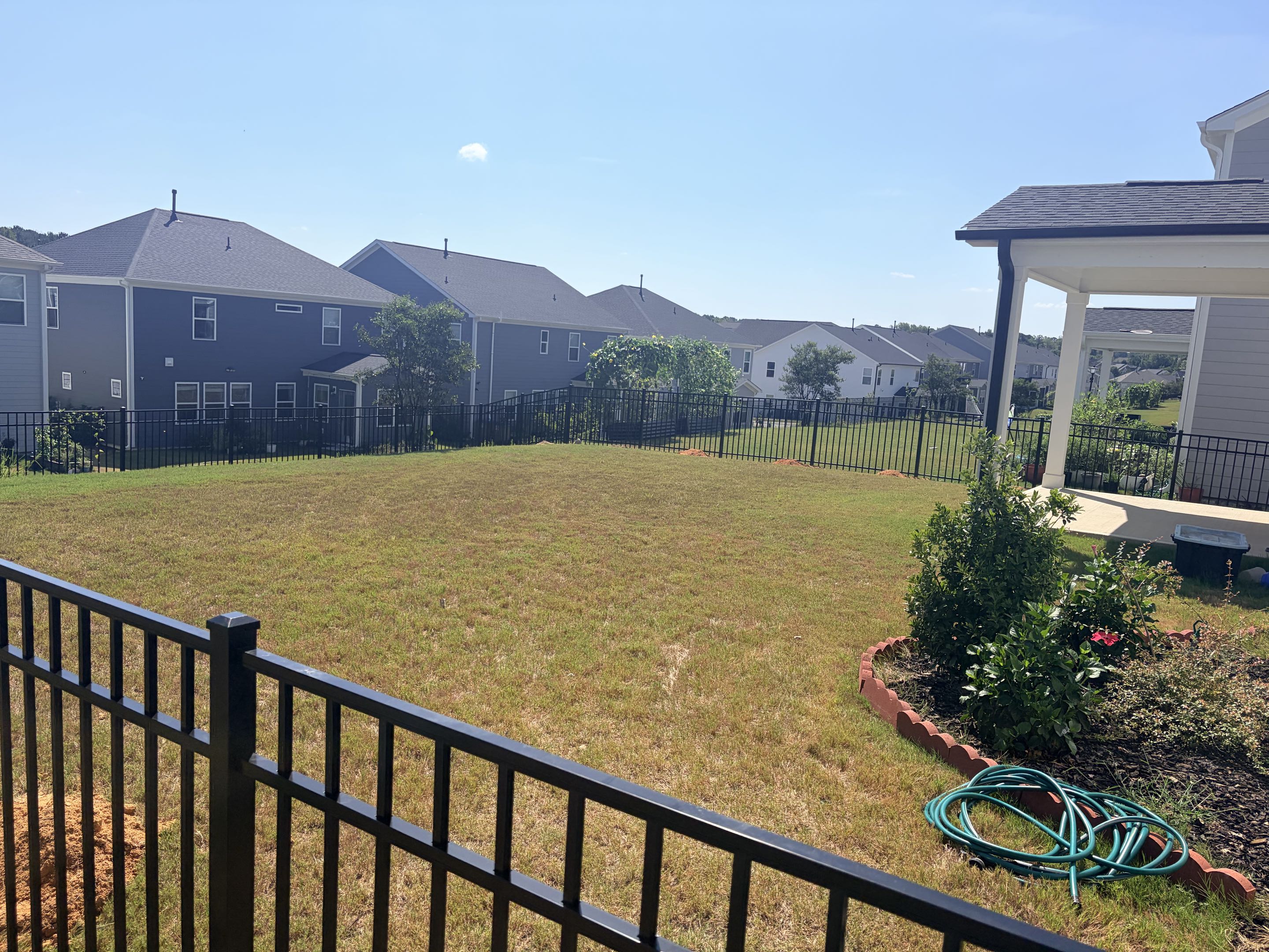 Wake Forest, NC - The project involved the installation of 110 linear feet of 4-foot high, 3-rail aluminum fencing. Each rail was meticulously measured, cut, and assembled to ensure a perfect fit. The aluminum material was chosen for its durability and resistance to corrosion. A single gate was integrated into the fencing, designed for easy access while maintaining security. The gate was equipped with a smooth-rolling hinge system to ensure longevity and ease of use. The posts were securely anchored into the ground, ensuring stability and resilience against external forces. The entire installation process adhered to industry standards, resulting in a seamless and aesthetically pleasing fence that met the client's expectations.