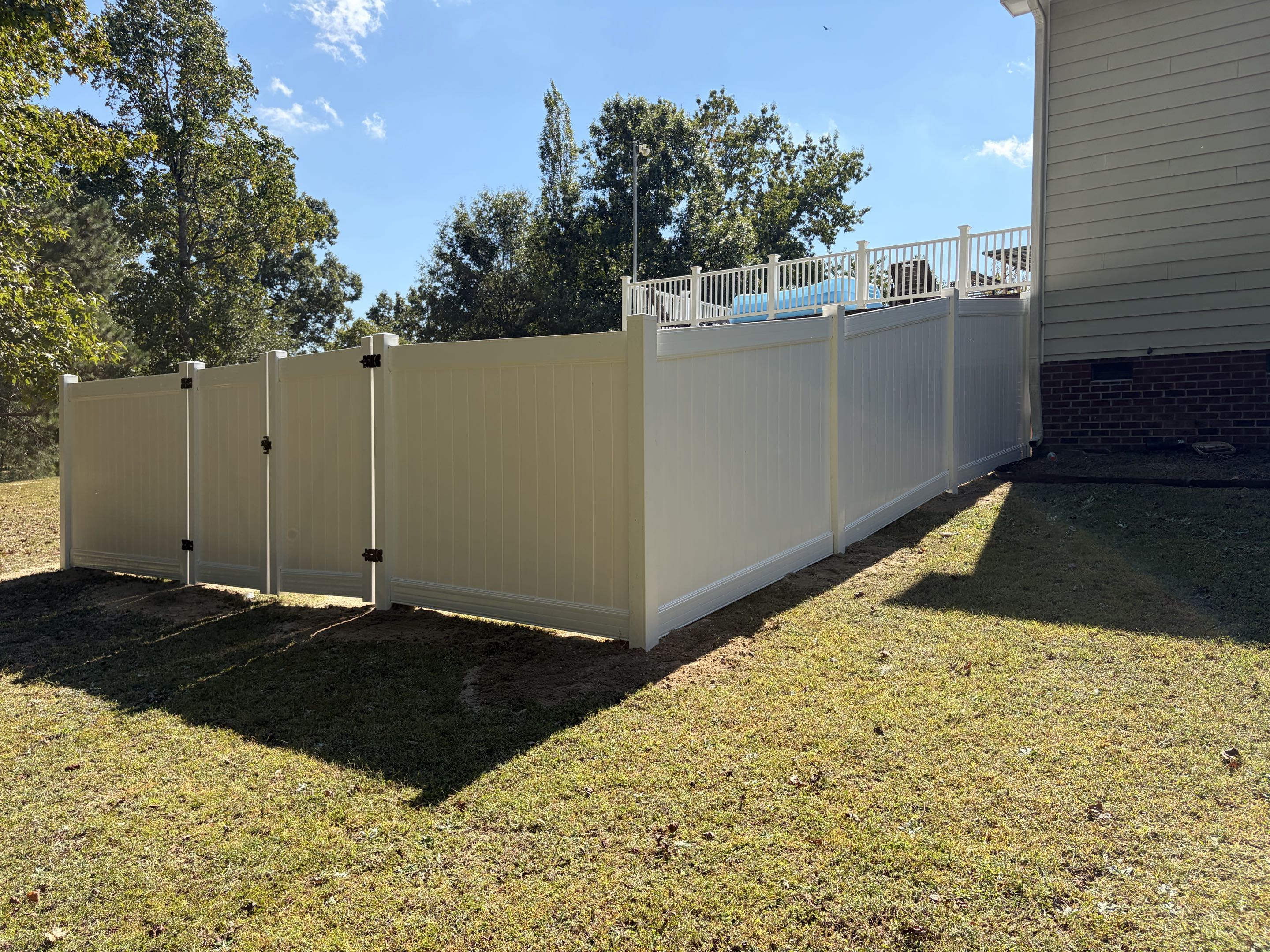 Clayton, NC - Another successful vinyl fence project completed! This installation featured 80 feet of 6-foot privacy vinyl fencing, ensuring a secure and private backyard for the family pet. The project included an 8-foot double gate, providing easy access while maintaining the fence's integrity. The meticulous attention to detail and precision in measuring and cutting ensured a perfect fit for the client's needs. The vinyl material was chosen for its durability and low maintenance, making it an ideal choice for the area. The installation was completed efficiently, leaving the backyard both secure and aesthetically pleasing.