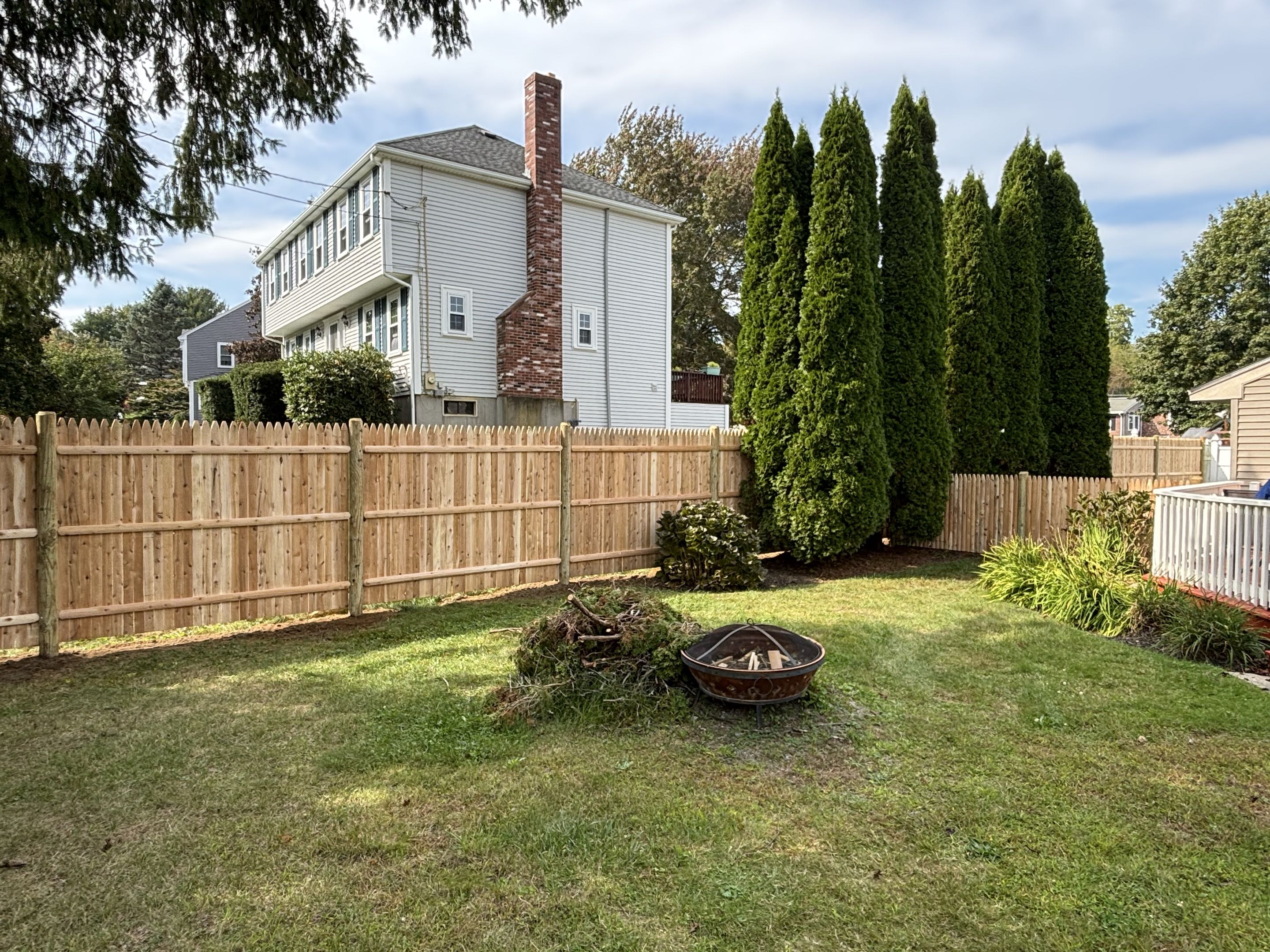 Medway, MA - A privacy cedar stockade fence was meticulously crafted and installed, featuring a combination of 6-foot and 4-foot cedar planks. Each plank was carefully selected for its quality and durability, ensuring a long-lasting structure. The 6-foot planks provided the primary height, offering substantial privacy, while the 4-foot planks were used for specific sections to enhance visual appeal and functionality. The final result is a beautiful, robust fence that enhances the privacy and aesthetic value of the property.