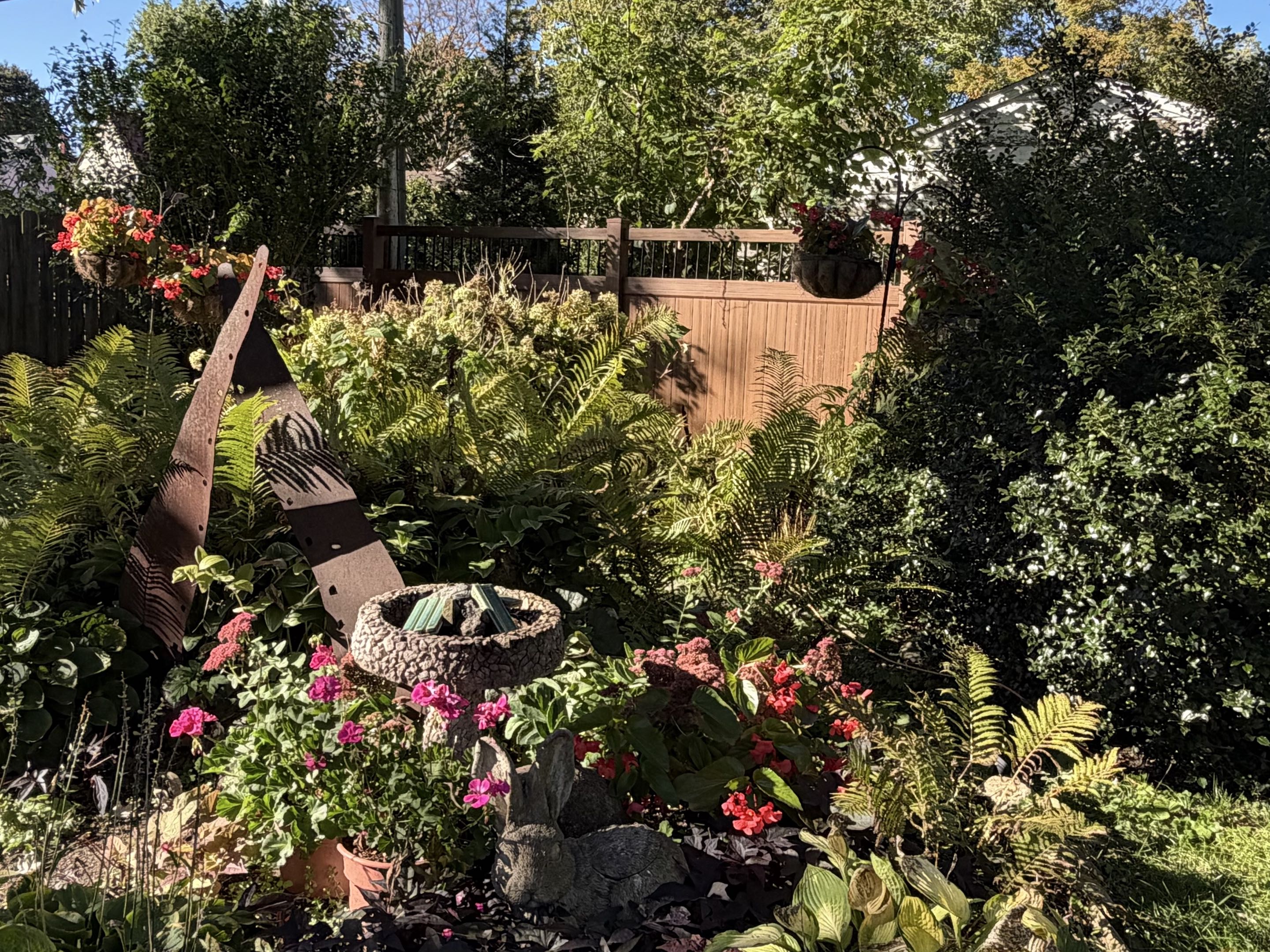 Ann Arbor, MI - We are in Ann Arbor, Michigan, putting up this local walnut vinyl fence with spindles. This is a more refined fence that adds to the backyard oasis.