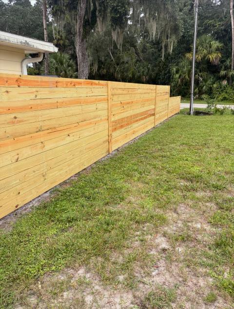 New Smyrna Beach, FL - Another great transformation in New Smyrna Beach! 🌴 We recently tore out an old, worn-out wood fence and replaced it with a modern horizontal wood fence, supported by powder-coated black steel PostMaster posts. Our crew did a heck of a job bringing this project together! The combination of the clean horizontal design and the strength of the PostMaster posts gives this fence a modern look while providing the long-term durability and structural support homeowners want. From the posts to the finished product, this is a fence built to look great and stand strong for years to come. 