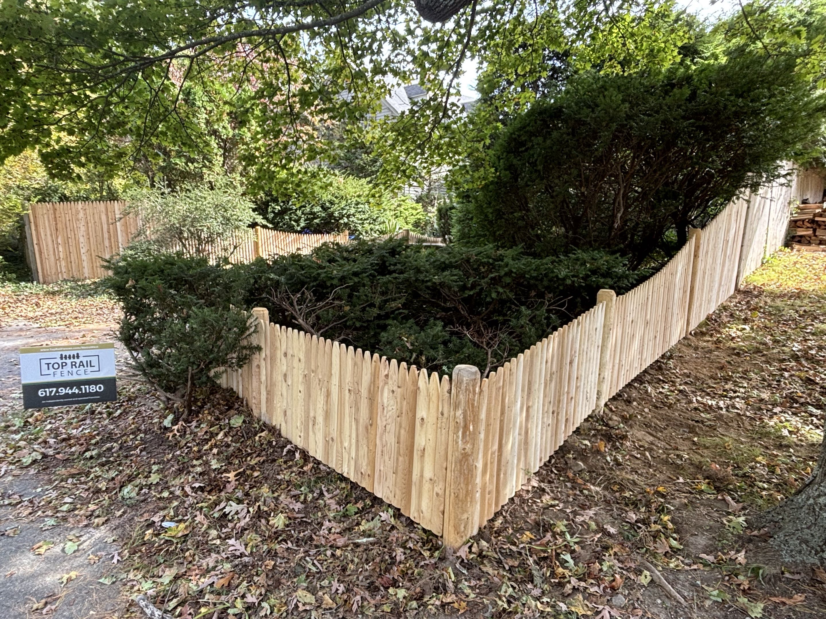 Dover, MA - A cedar stockade fence was erected, featuring varying heights and tapers for privacy and aesthetic interest. The cedar was chosen for its natural resistance to decay and insects, ensuring longevity. Precision was key in aligning and securing each post, resulting in a seamless and robust structure. The final product offers both functionality and beauty, transforming the property's perimeter.
