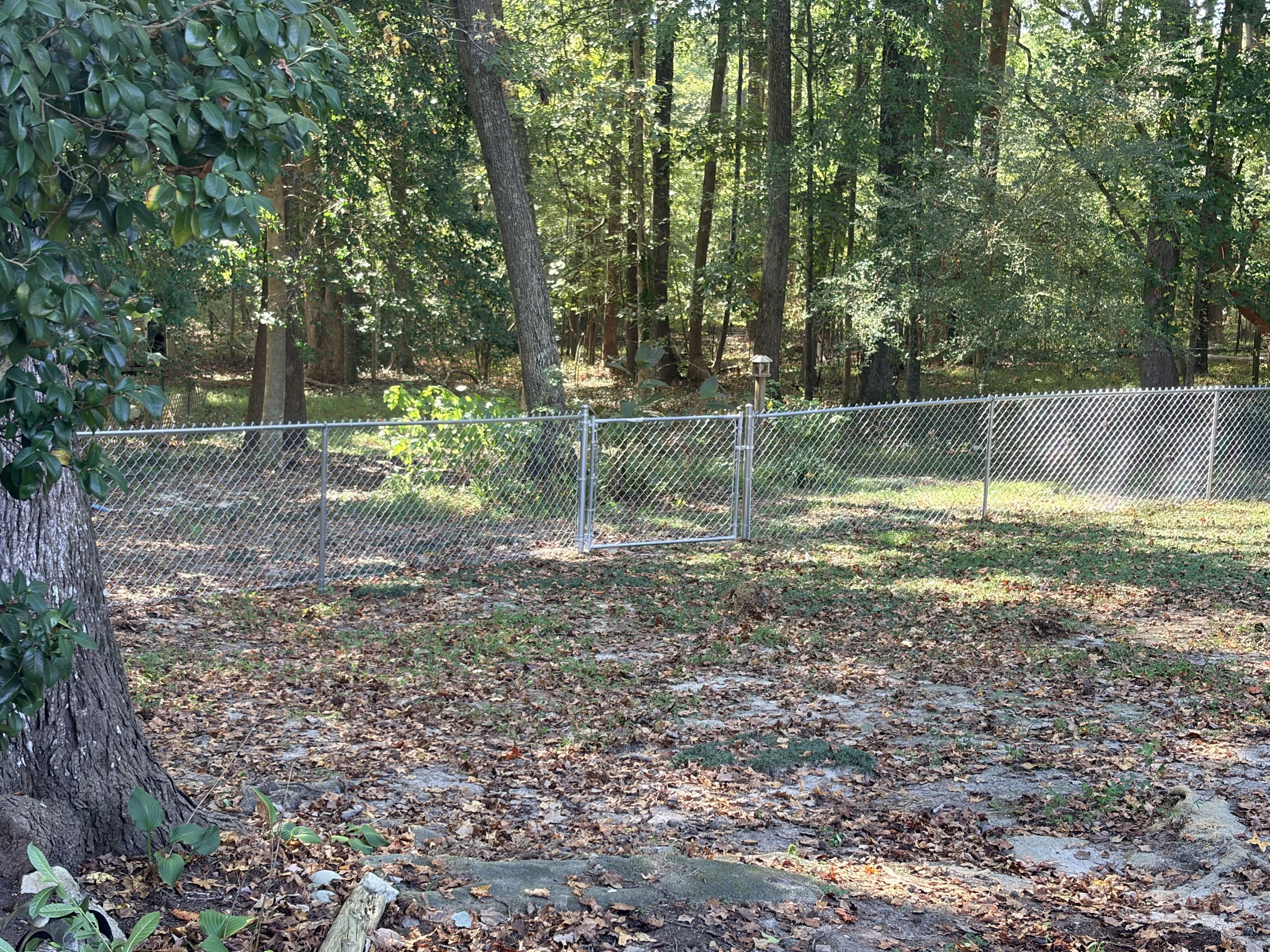 Raleigh, NC - A 200-foot stretch of 4-foot-tall galvanized chain-link fencing was expertly installed, featuring a single gate for convenient access. This robust, durable fence was chosen to provide a secure perimeter, ensuring the safety and protection of beloved pets and family members. The galvanized material was selected for its resistance to rust and corrosion, promising long-lasting performance. Each link was meticulously installed to guarantee a tight, secure fit, creating an effective barrier. The single gate was positioned for easy entry and exit, balancing security with practicality. This project was completed with precision and care, resulting in a reliable, aesthetically pleasing fence.