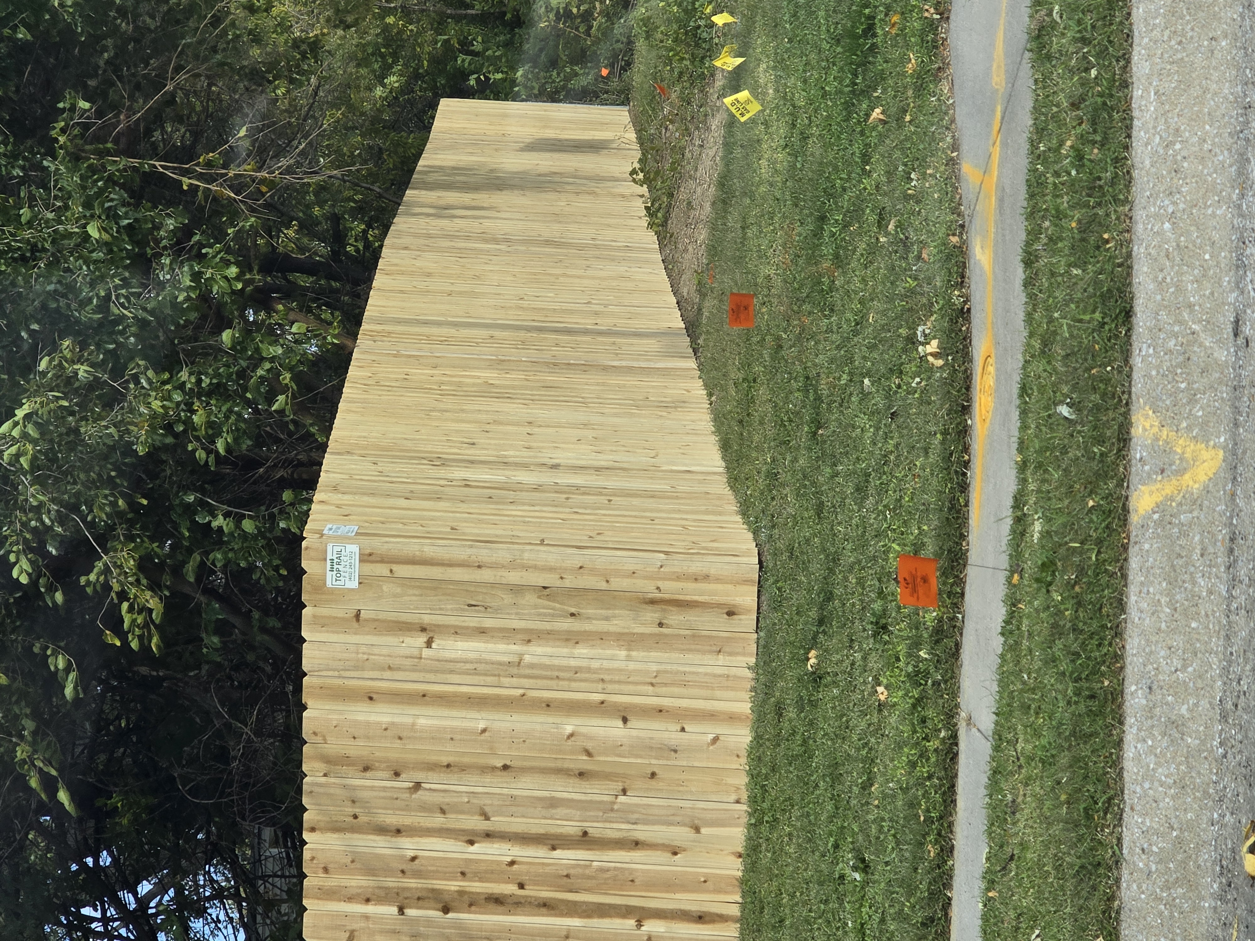Omaha, NE - We crafted a beautiful cedar wood privacy fence, enhancing the backyard's seclusion and ensuring the safety of the family's beloved dog.