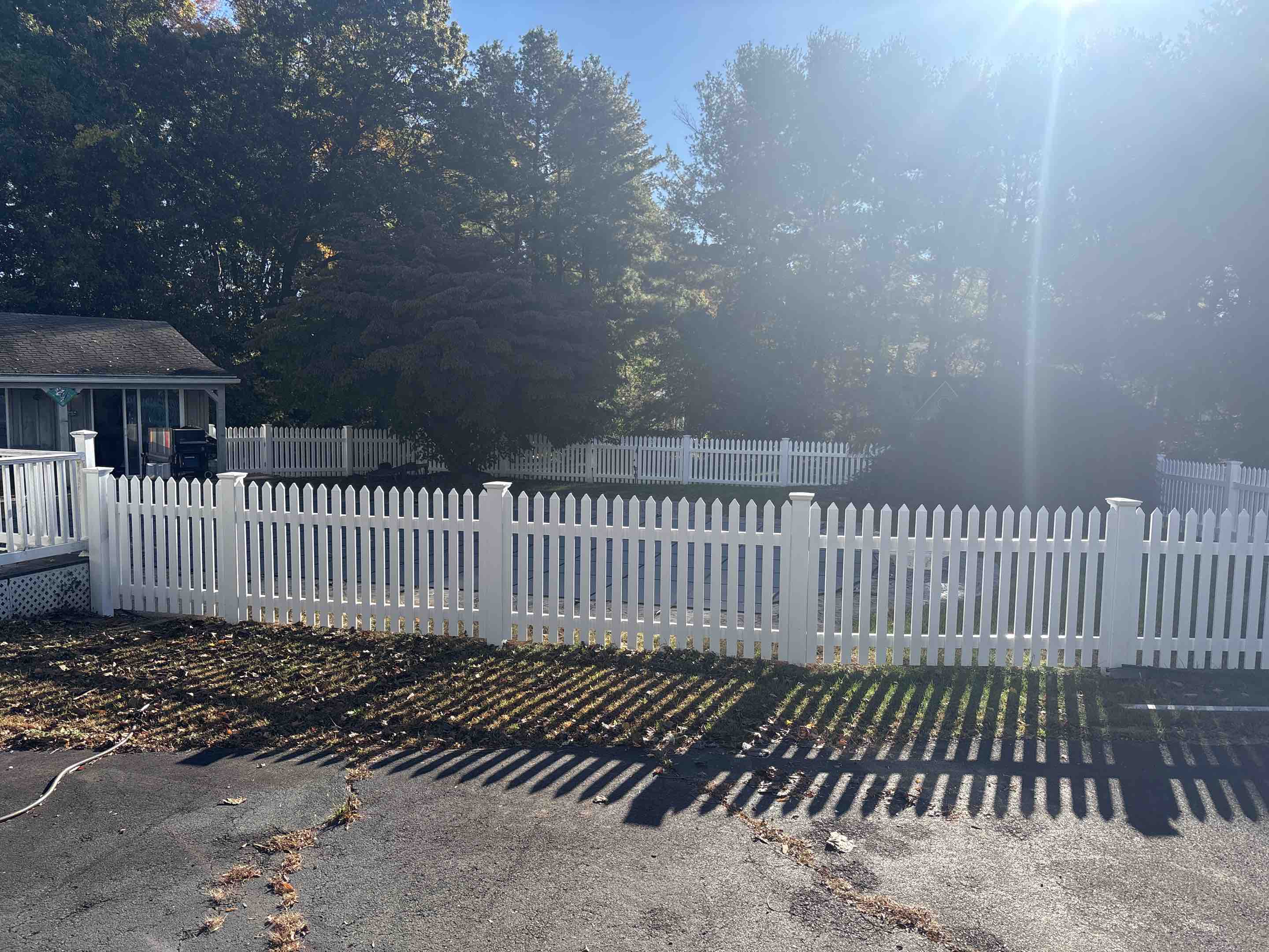 Wallingford, CT - Finishing touches on a beautiful new white vinyl picket fence!