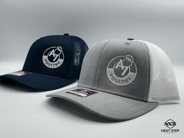 We made a bulk order of custom hats for A7 Poultry. The hats are made with direct-to-cap stitching for durability and a sharp look. They're a great promotional item for customers, employees, and associates. The feedback we've received is that people usually choose the gray hats over the navy ones, and they've already placed another order for additional hats.  
We made a bulk order of custom hats for A7 Poultry. The hats are made with direct-to-cap stitching for durability and a sharp look. They're a great promotional item for customers, employees, and associates. The feedback we've received is that people usually choose the gray hats over the navy ones, and they've already placed another order for additional hats.