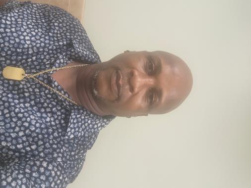 Man wearing a patterned shirt and necklace, reflecting professionalism and customer service, relevant to RupCoe Plumbing, Heating & Air Conditioning's positive client experiences.