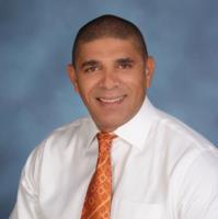 Dr. Carlos Carrazana