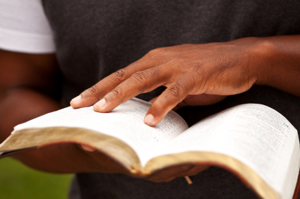 man holding open bible