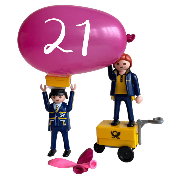 The Little Mail Carrier figures celebrating Postcrossing’s 21st anniversary with a large pink balloon marked 21 and a tiny yellow mail cart