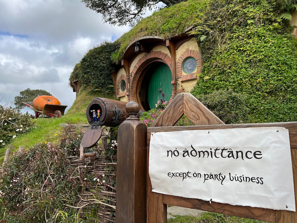 Hobbit-hole doorway at Hobbiton with a sign reading No admittance except on party business.