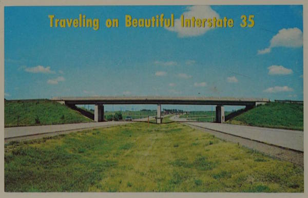 A postcard showing Interstate 35, just grass and the highway, with a caption saying Traveling on Beautiful Interstate 35