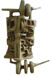 Machado's sculpture Abstract sculpture by João Machado, vertical form with carved geometric cavities and projections.