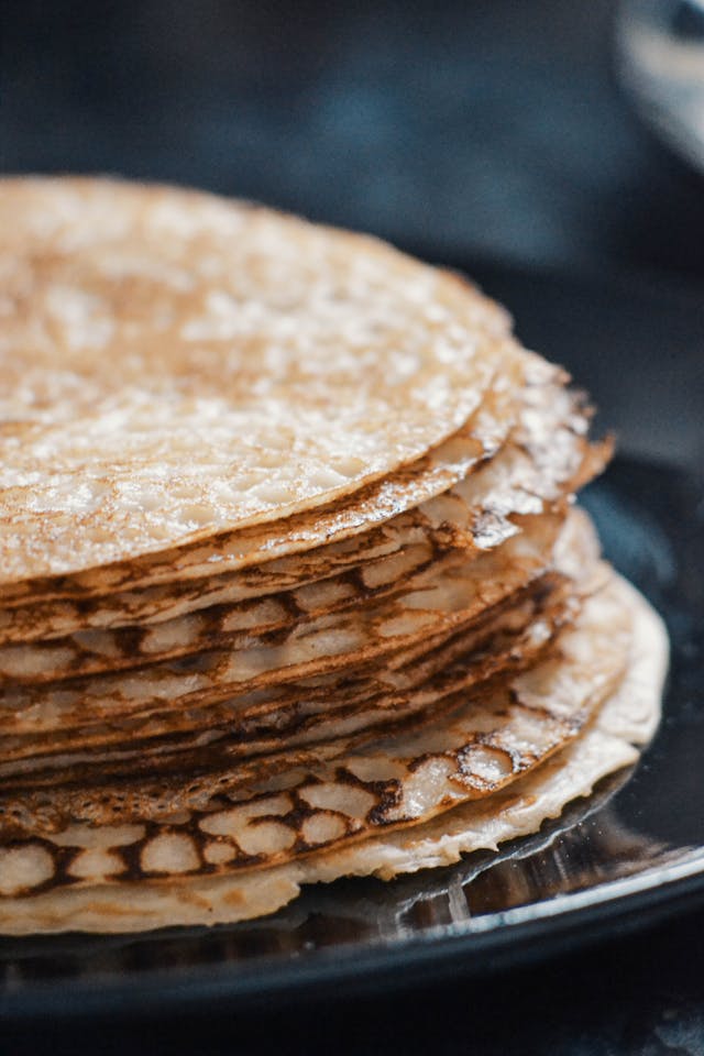 A photo of a stack of crepe-style pancakes