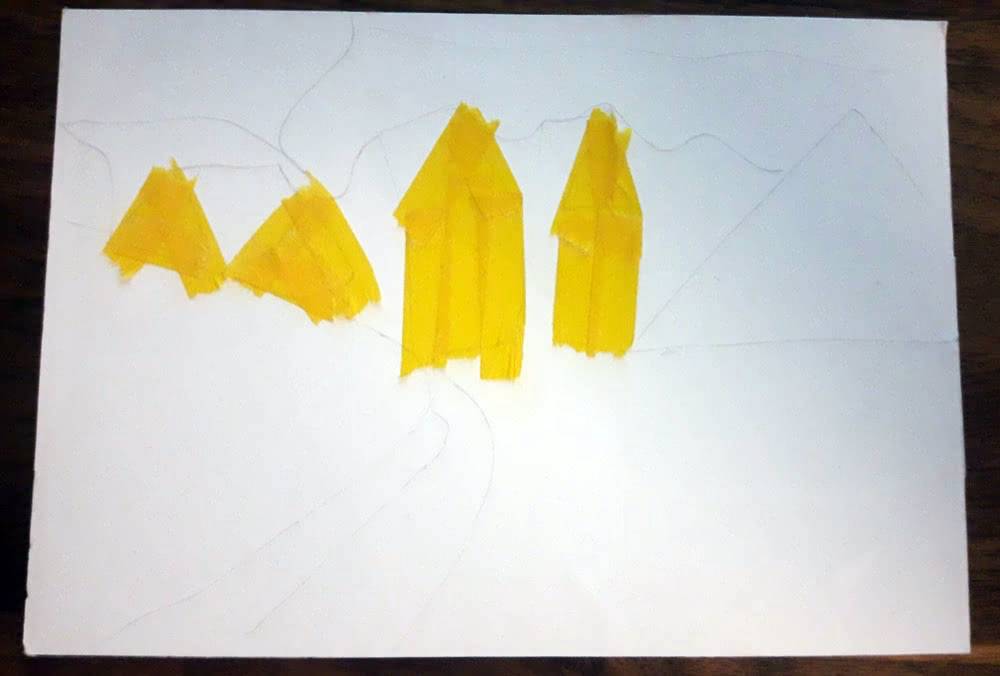 First step of a washi tape postcard, with faint pencil outlines and several yellow house shapes already covered in tape.