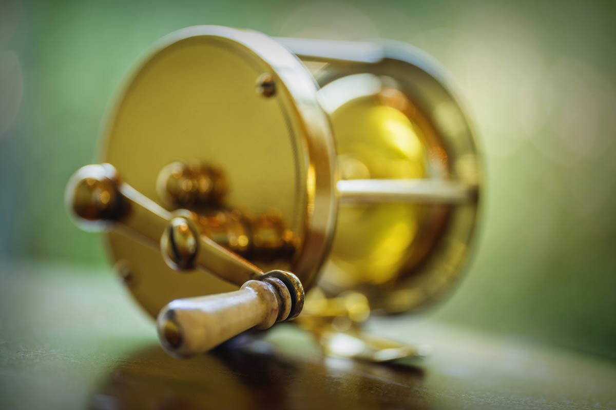Closeup of antique brass fishing reel StockFreedom Premium Stock
