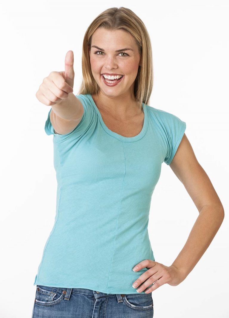 A young woman is giving a thumbsup and smiling at the camera
