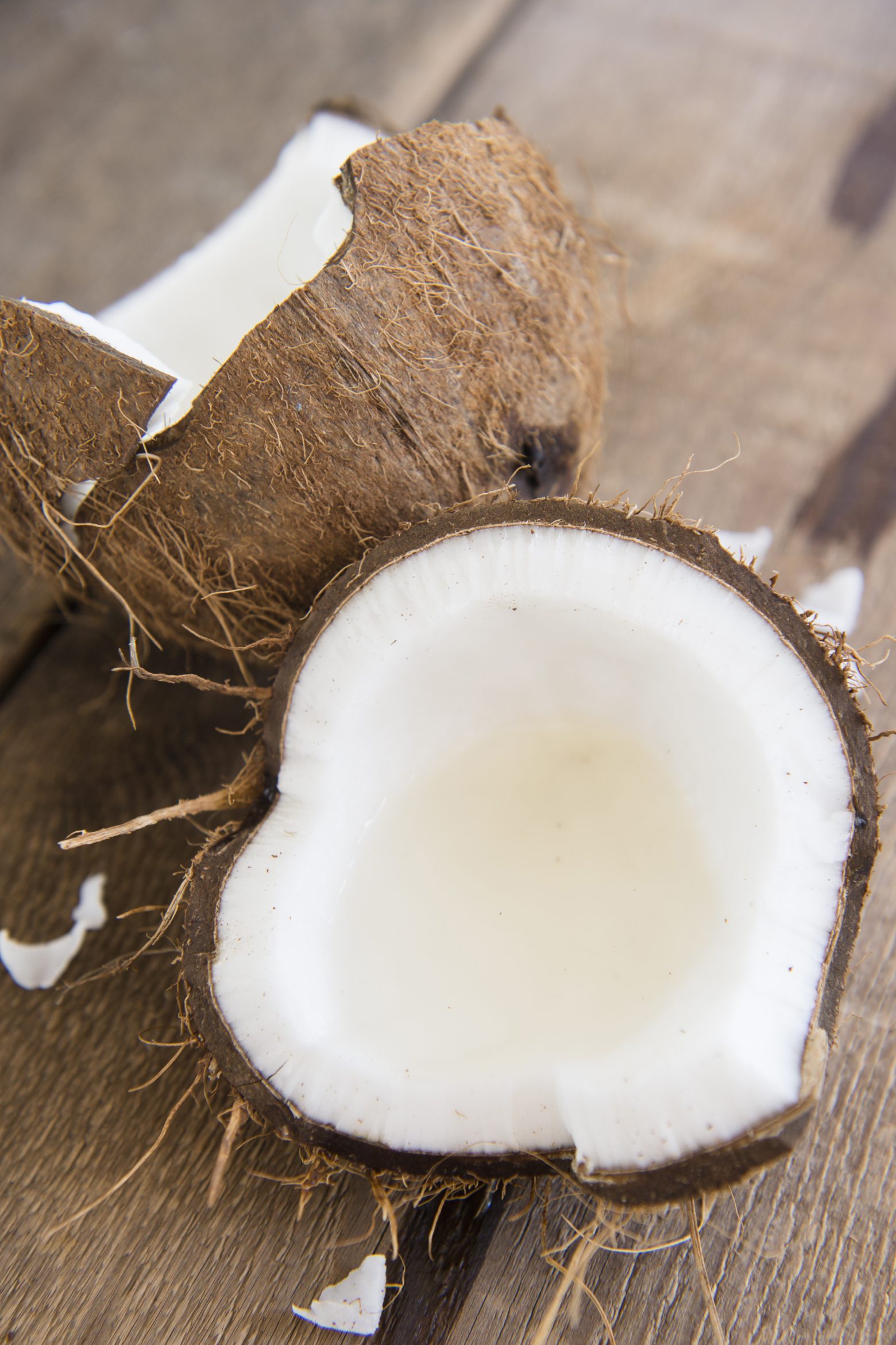 Glass of coconut milk with a split coconut StockFreedom Premium