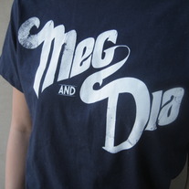 Meg & Dia white on blue T-shirt
