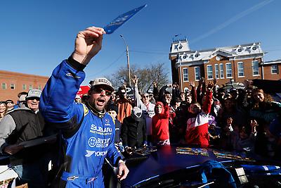 Excited fans gather round to collect a momento to go home with from Travis Pastrana.