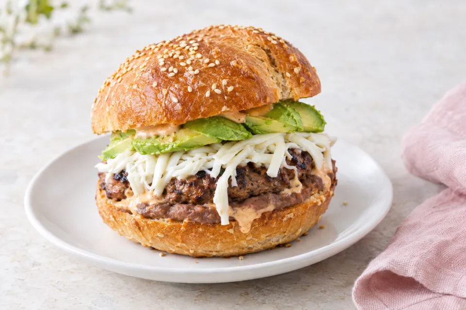 Cemita Burger with Refried Beans, Chipotle Mayo, Avocado, and Oaxacan Cheese