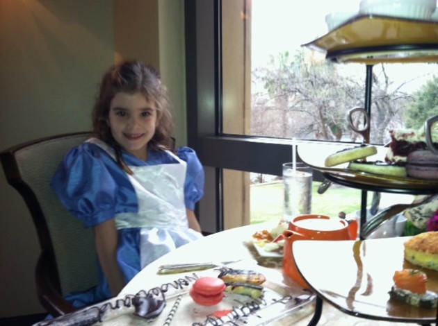Charlotte Sigler (daughter of curator Danielle Sigler) wore a blue pinafore to the Mad Hatter's tea party at the Four Seasons.