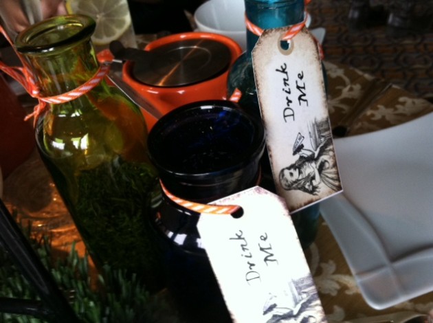 Jars holding tea leaves have mischievous labels at the Mad Hatter's tea party.