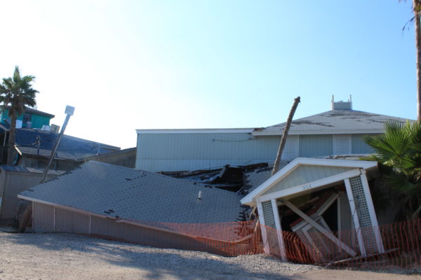 1)	A battered Port Aransas business sits in a sink hole (Port Aransas, Texas)