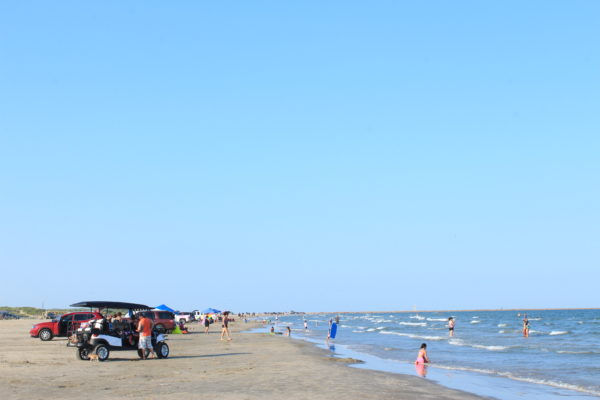 Tourists line a Port Aransas beach.