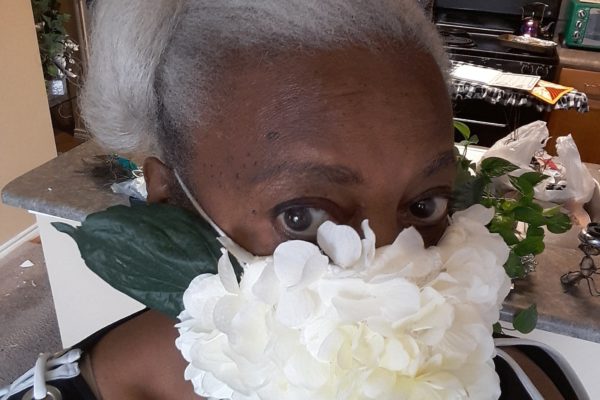 Nezzie Shabazz and her silk flower "mum" mask.