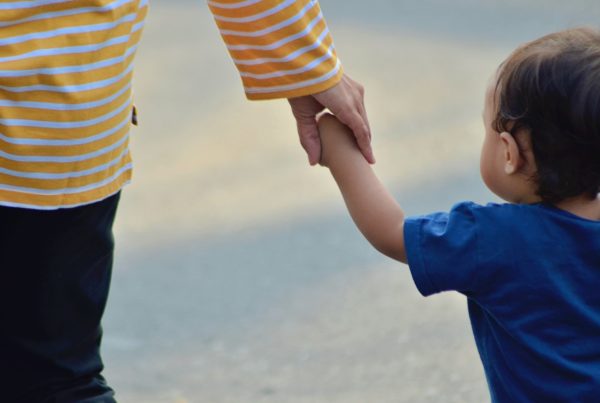 adult and child holding hands