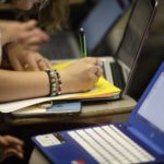 a college student with a pencil and laptop