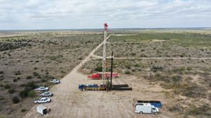 Oil rig equipment and trucks in a large rural area
