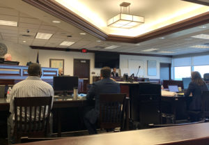 a man and his lawyer in a courtroom
