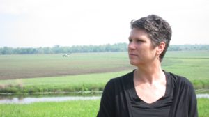 a woman standing in front of a large field