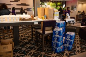 bottles of water stacked up near a table at a la quinta hotel