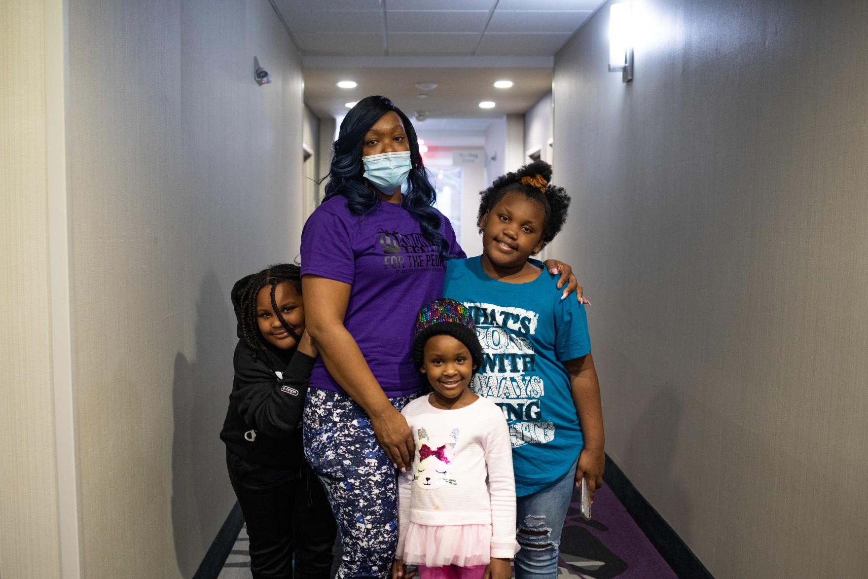 a woman posing with her three children