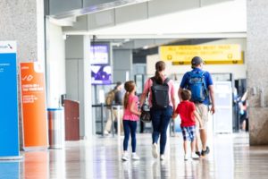 a small group of people walk through the airport
