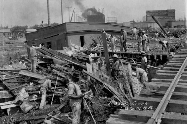 People attempt to go through debris in the wake of the 1921 flood on San Antonio's West Side.