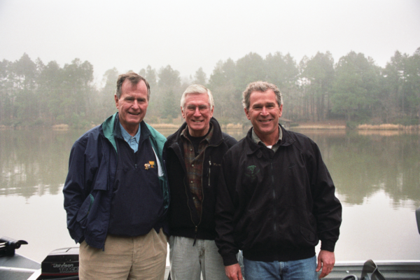 Neal Bushes Neal Spelce, center, with George H.W. Bush, left, and George W. Bush.