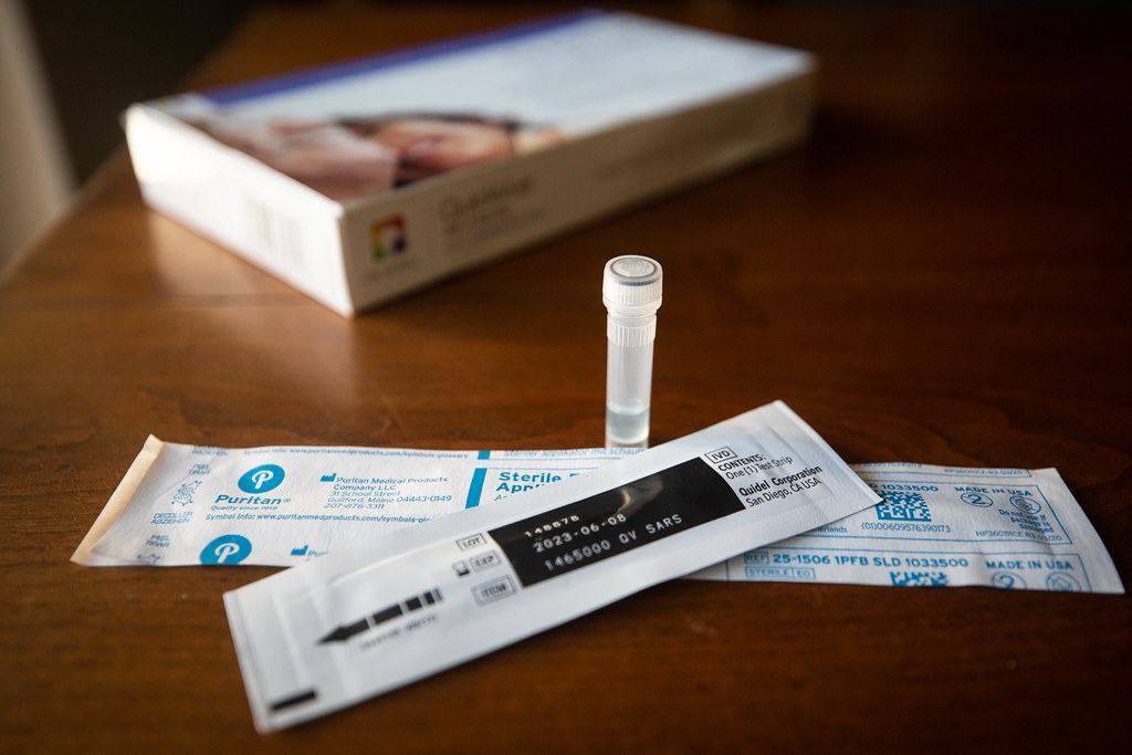 The contents of an at-home COVID-19 test kit, on a table