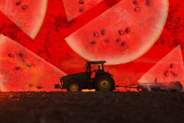 A shadowy tractor plows the ground as a deep read collage of watermelon slices looms in the background