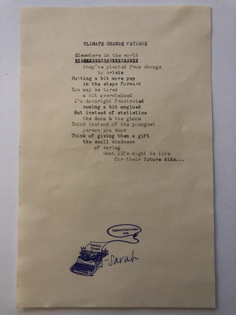 a photo of the typewritten poem on a torn half-sheet of yellow paper