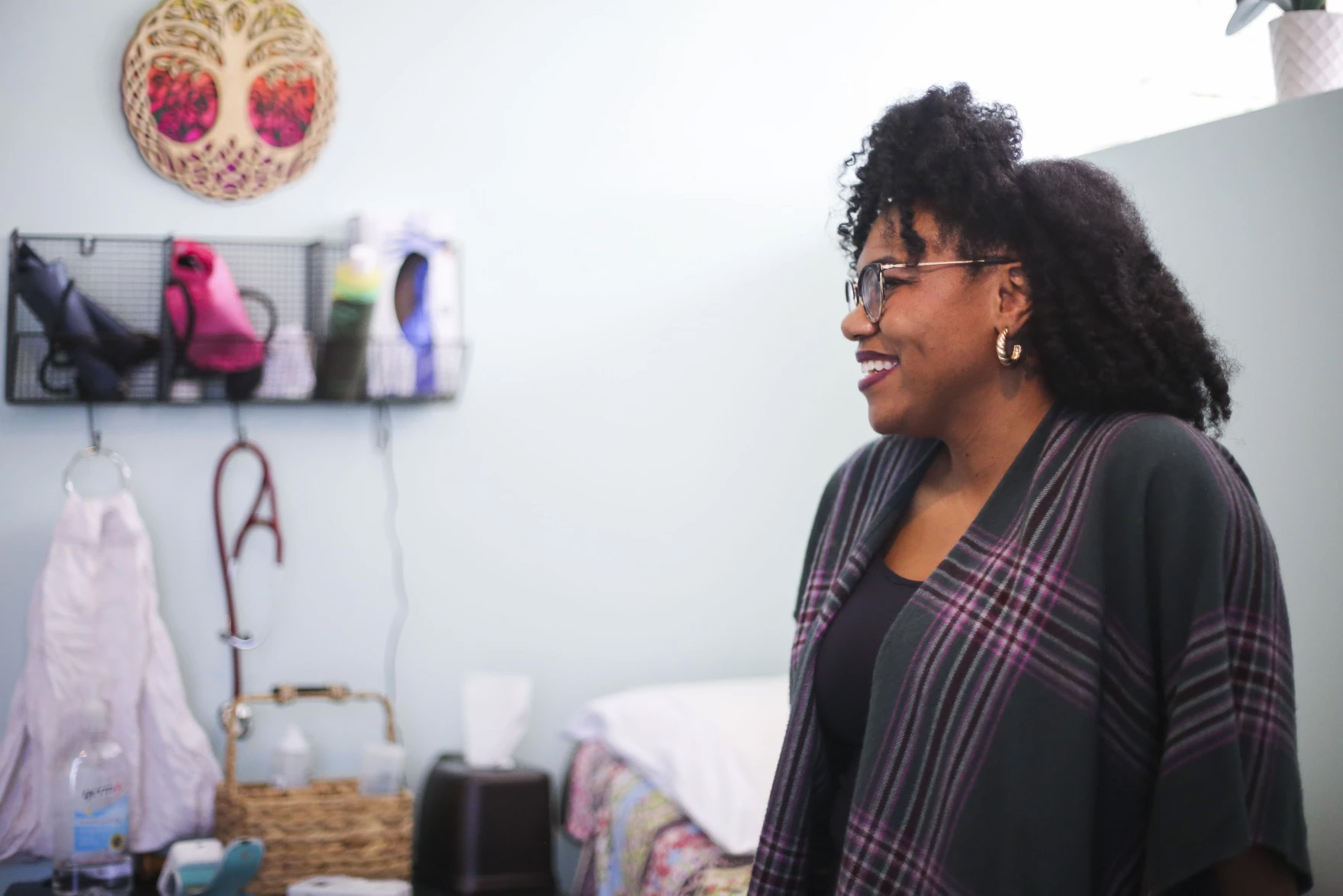 A woman looks off to the side and smiles. This is Krystal Brown.