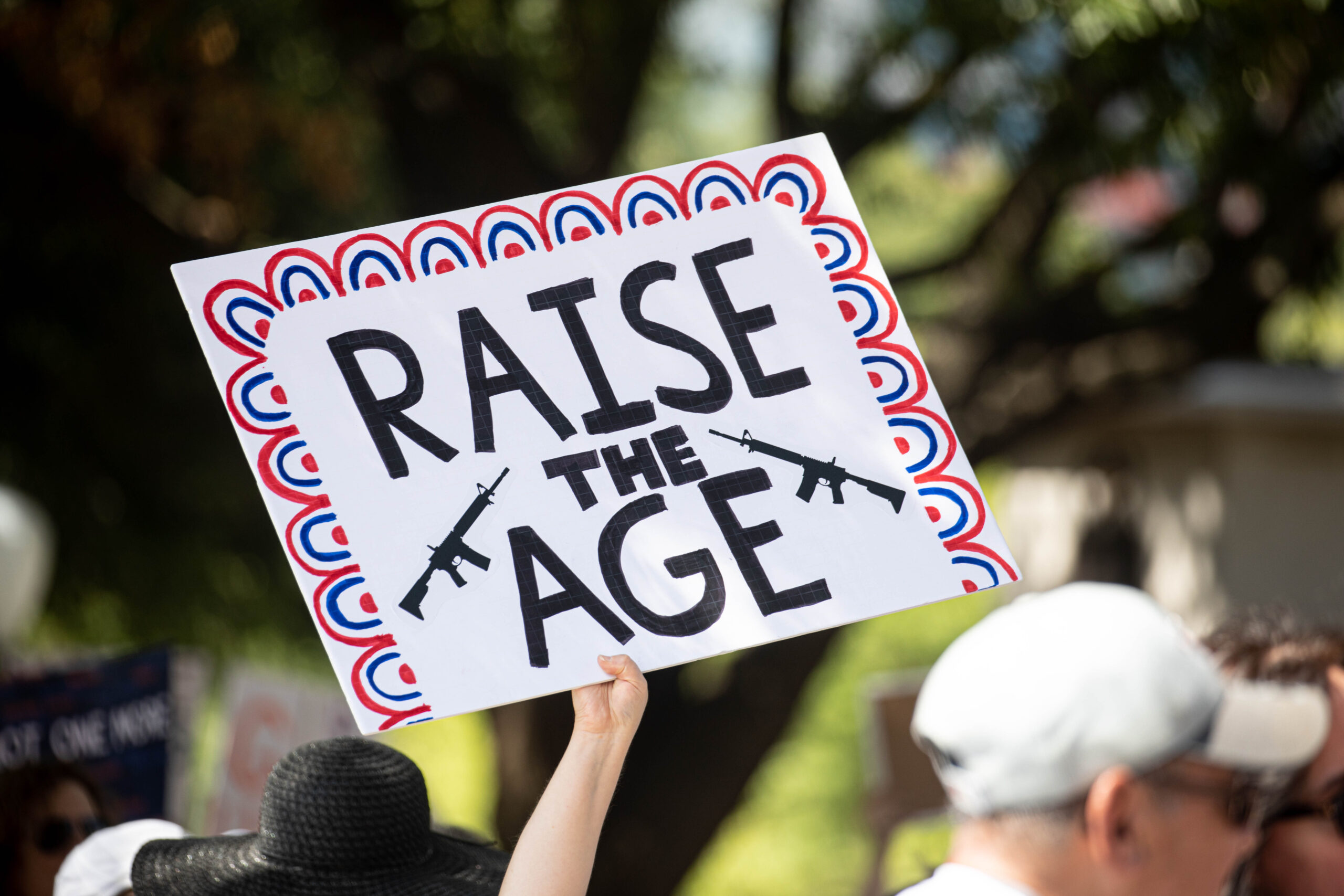 A sign is held up reading 