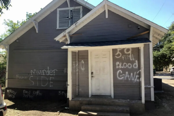 Photo of a Department of Family and Protective Services children without placement home in Belton visited by court-appointed monitors checking on the living conditions of children in the care of the state. Graffiti on the home reads "murder side" and "blood gang."