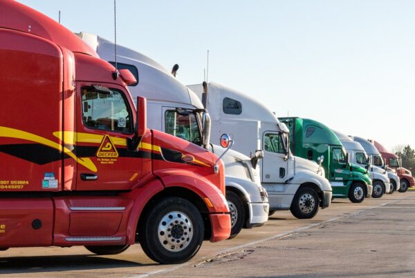 I row of semi trucks are seen.