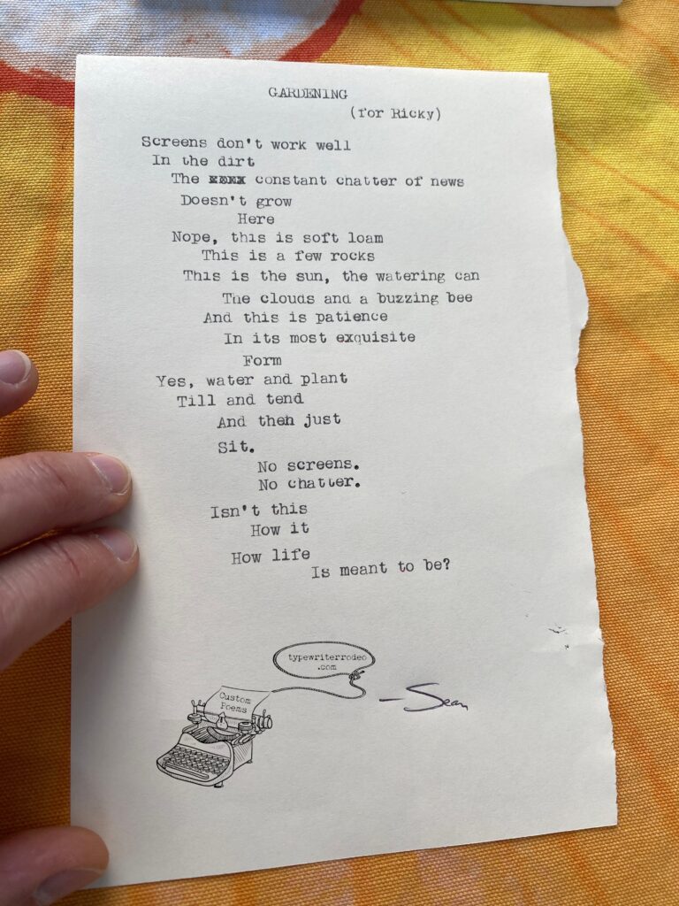 A photo of the typewritten poem on a torn half sheet of light yellow paper.